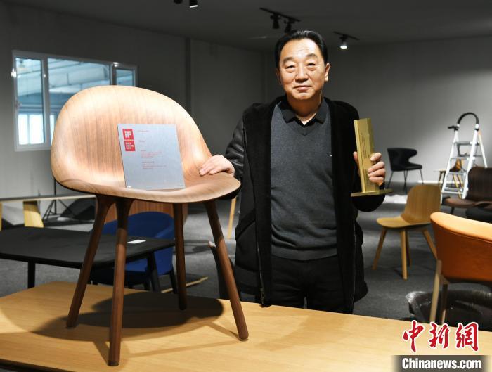 圖為產(chǎn)業(yè)園內(nèi)的一家公司負(fù)責(zé)人展示獲得德國IF設(shè)計金獎的椅子?！∷蚊魸?攝